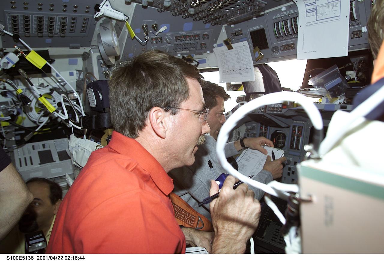 S100-E-5136 (21 April 2001) --- On Endeavour's forward flight deck, astronauts Kent V. Rominger (foreground), mission commander, and Jeffrey S. Ashby, pilot, synchronize their efforts during pre-docking operations with the International Space Station (ISS). The image was recorded with a digital still camera.