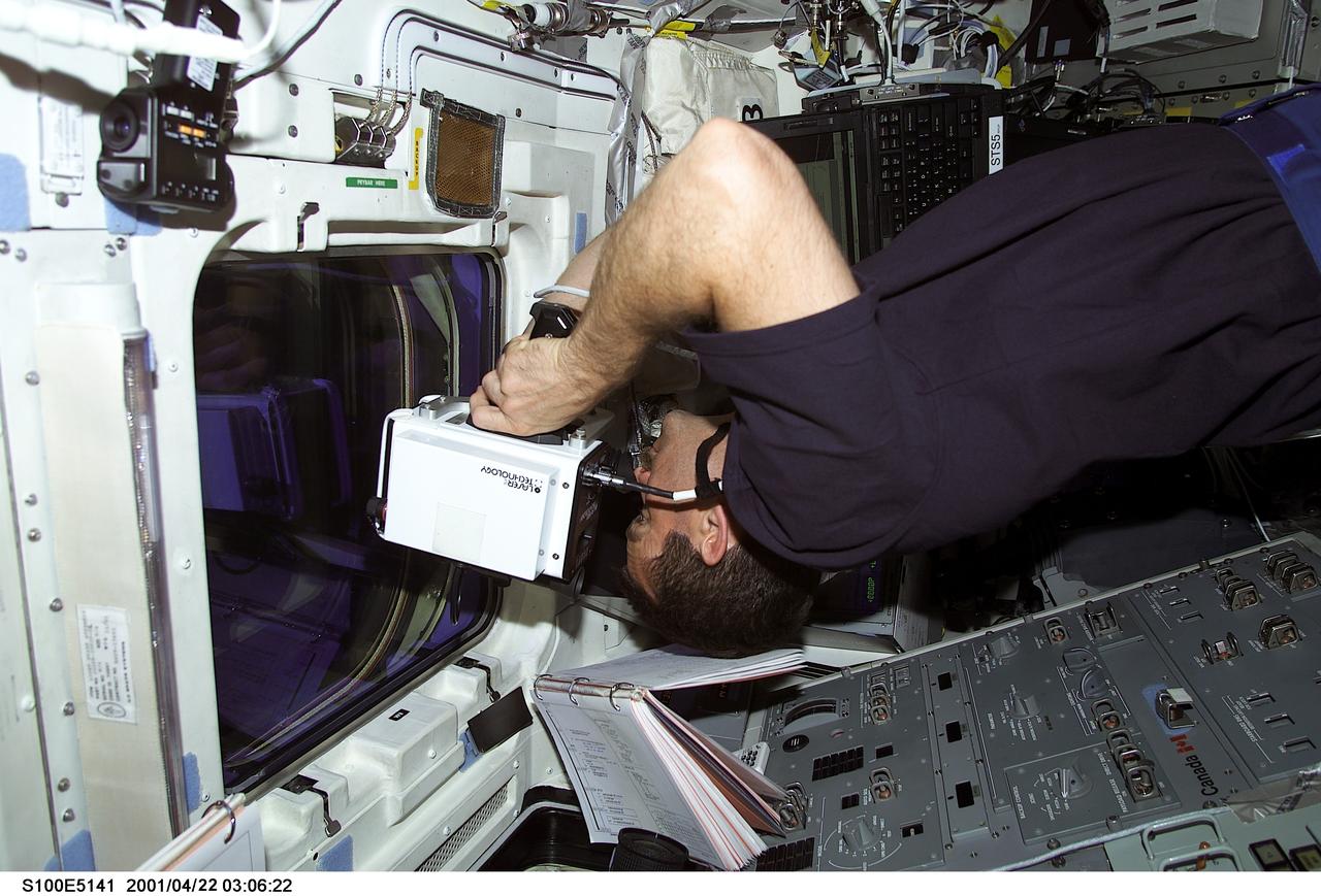 S100-E-5141 (21 April 2001) --- Astronaut Chris A. Hadfield of the Canadian Space Agency (CSA) uses a laser ranging device to keep up with the precise location of the International Space Station (ISS) from his post on the aft flight deck of the Space Shuttle Endeavour. The image was recorded with a digital still camera.