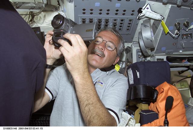 NASA image: MS Phillips uses a video camera on the flight deck of Endeavour during STS-100