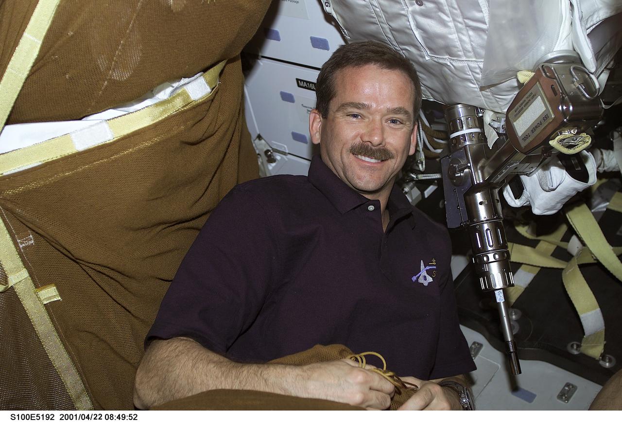 S100-E-5192 (21 April 2001) --- Astronaut Chris A. Hadfield of the Canadian Space Agency (CSA), scheduled as one of two mission specialist participants in April 22 extravehicular activity (EVA) with the International Space Station (ISS), inspects equipment on the middeck of the Space Shuttle Endeavour. The image was recorded with a digital still camera.