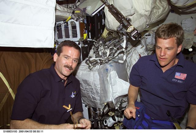 NASA image: MS Hadfield and MS Parazynski go over EVA equipment on the middeck of Endeavour