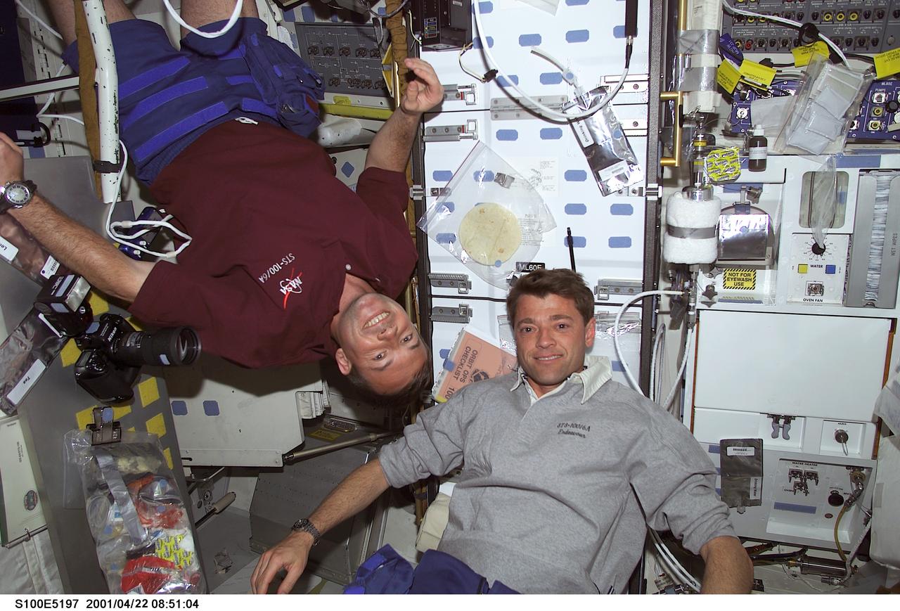 S100-E-5197 (21 April 2001) --- Cosmonaut Yuri V. Lonchakov (left), mission specialist representing Rosaviakosmos, and astronaut Jeffrey S. Ashby, pilot, meet near the galley on the middeck of the Earth-orbiting Space Shuttle Endeavour. The photo was recorded with a digital still camera.