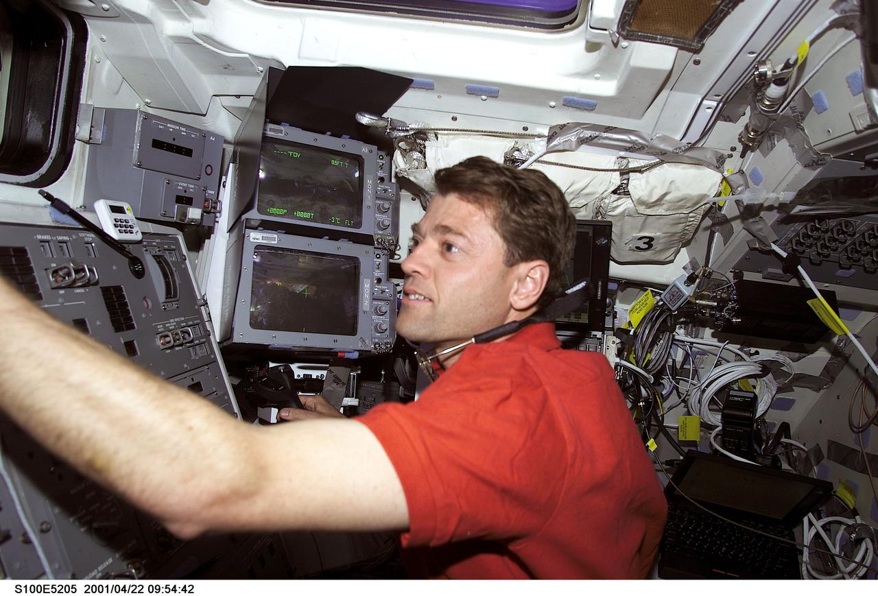 S100-E-5205 (22 April 2001) --- Astronaut Jeffrey S. Ashby, STS-100 pilot, remains on Endeavour's flight deck as two crew mates (out of frame) on the deck below get ready for space walk duty.  The image was recorded with a digital still camera.