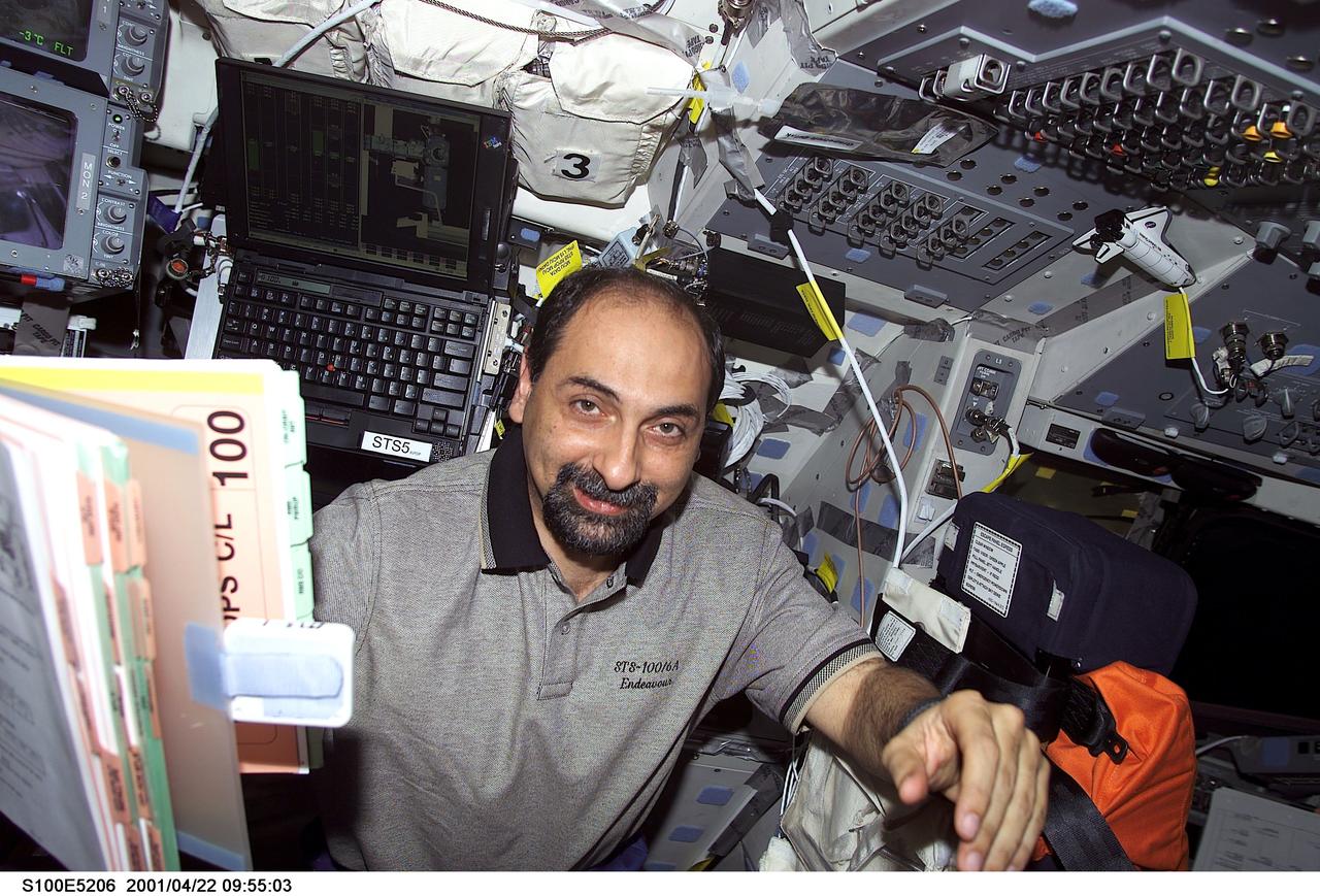 S100-E-5206 (22 April 2001) --- Astronaut Umberto Guidoni, STS-100 mission specialist representing the European Space Agency (ESA), remains on Endeavour's flight deck as two crew mates (out of frame) on the deck below  get ready for space walk duty.  The image was recorded with a digital still camera.
