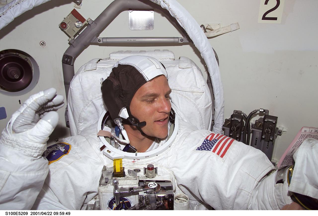 S100-E-5209 (22 April 2001) --- Astronaut Scott E. Parazynski, STS-100 mission specialist, appears ready to face a busy agenda outside the Space Shuttle Endeavour as he prepares to don his helmet gear and then exit the shuttle's airlock to share several hours of extravehicular work on the International Space Station (ISS) with astronaut Chris A. Hadfield (out of frame) of the Canadian Space Agency (CSA). This is the first of two scheduled walks to perform work on the orbital outpost. The scene was recorded with a digital still camera.