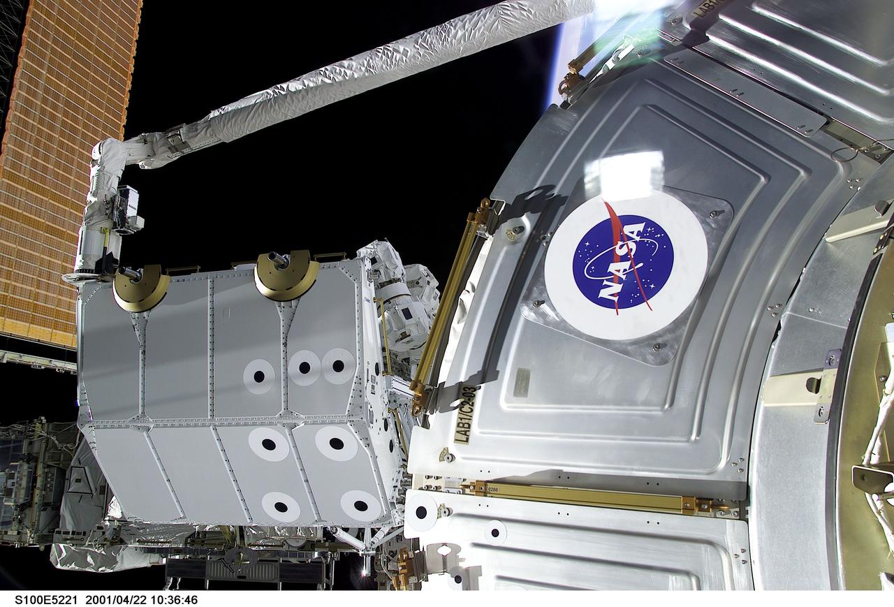 S100-E-5221 (22 April 2001) --- The  pallet that contains Canadarm2 and the UHF antenna that are to be installed during the first scheduled space walk on STS-100 is seen in the grasp of the Canadian-built Remote Manipulator System (RMS) robot arm on the Space Shuttle Endeavour. The Destiny laboratory is seen in the foreground of the digital still camera's image.