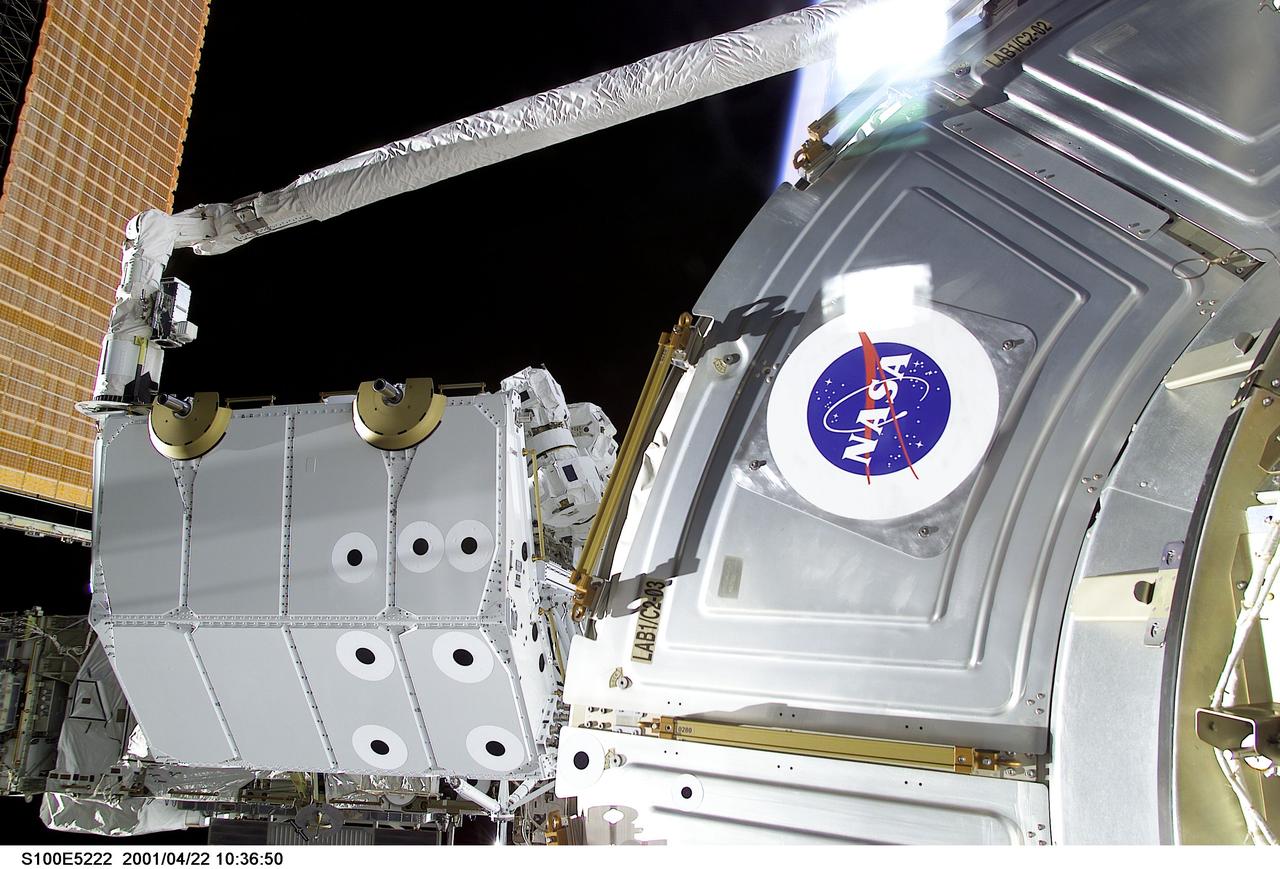 S100-E-5222 (22 April 2001) --- The  pallet that contains Canadarm2 and the UHF antenna that are to be installed during the first scheduled space walk on STS-100 is seen in the grasp of the Canadian-built Remote Manipulator System (RMS) robot arm on the Space Shuttle Endeavour.   The Destiny laboratory can be seen in the right foreground. The scene was recorded with a digital still camera.