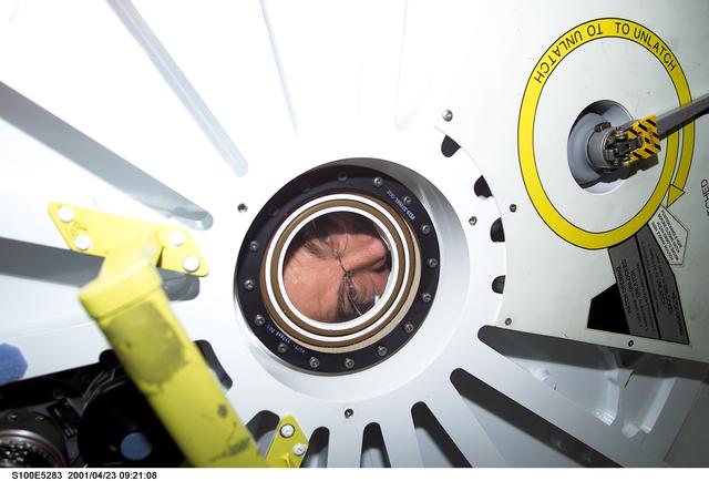 NASA image: Expedition Two's Jim Voss looks through the PMA2 window minutes before the STS-100 ingress