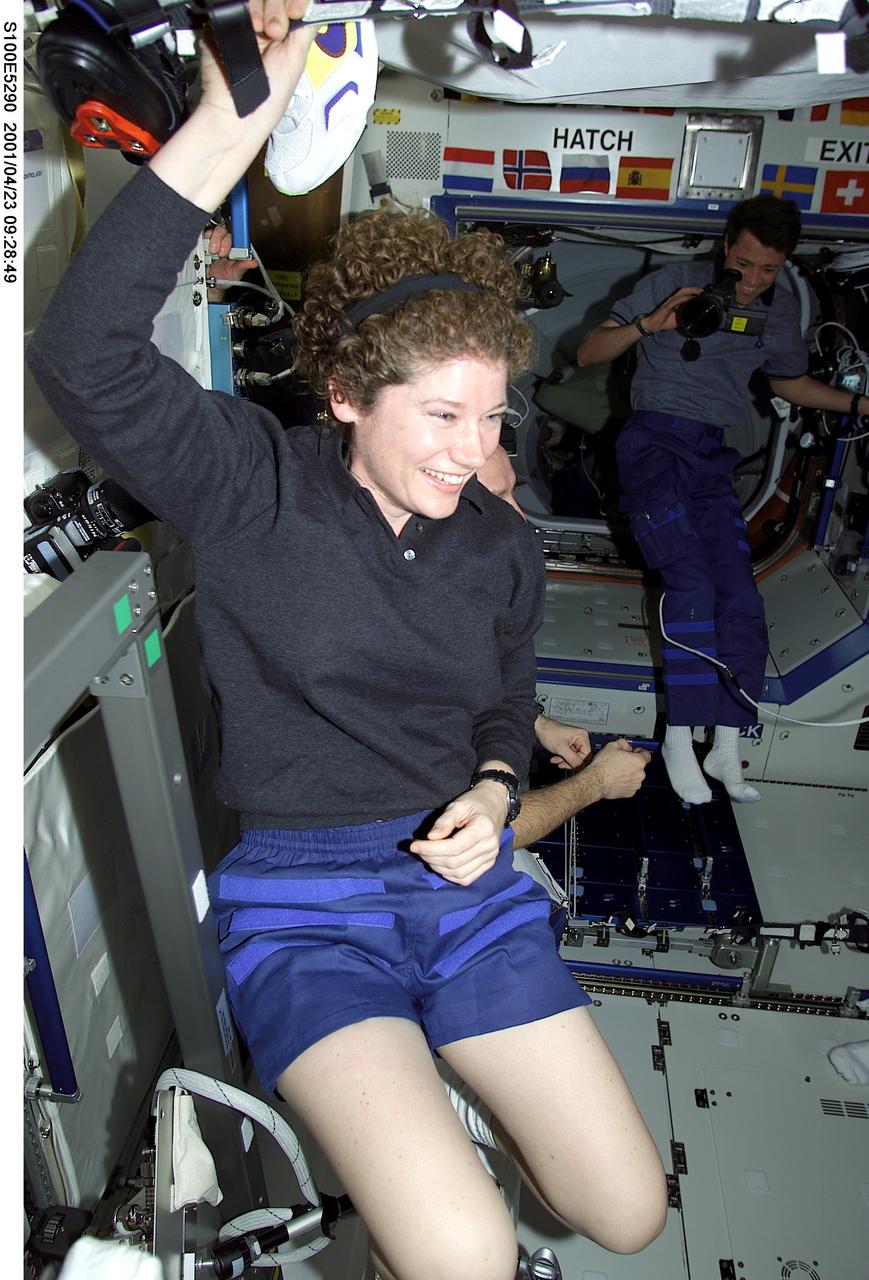 S100-E-5290 (23 April 2001)--- Astronaut Susan J. Helms, Expedition Two flight engineer, greets members of the STS-100 crew in the Destiny laboratory just after hatch opening. Astronaut Jeffrey S. Ashby, STS-100 pilot, documents the reunion in the background. The image was recorded with a digital still camera.