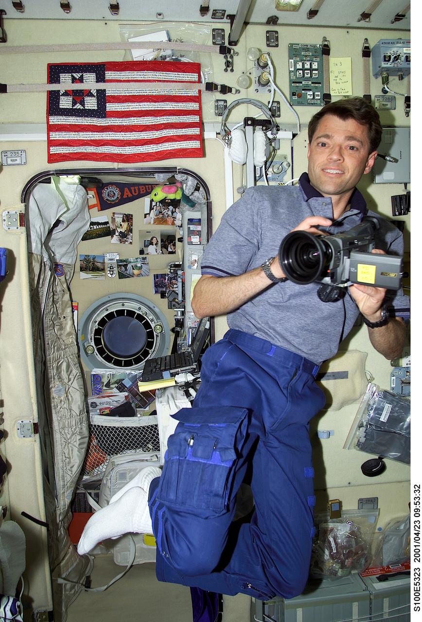 S100-E-5323 (23 April 2001) --- Astronaut Jeffrey S. Ashby, STS-100 pilot, prepares to document activity of his shuttle crew mates as well as members of the Expedition Two crew (out of frame) as he makes his first trip to the International Space Station (ISS). Hatch opening occurred around 4 a.m. (CDT) following a wakeup call from Houston's Mission Control earlier in the morning. The image was recorded with a digital still camera.