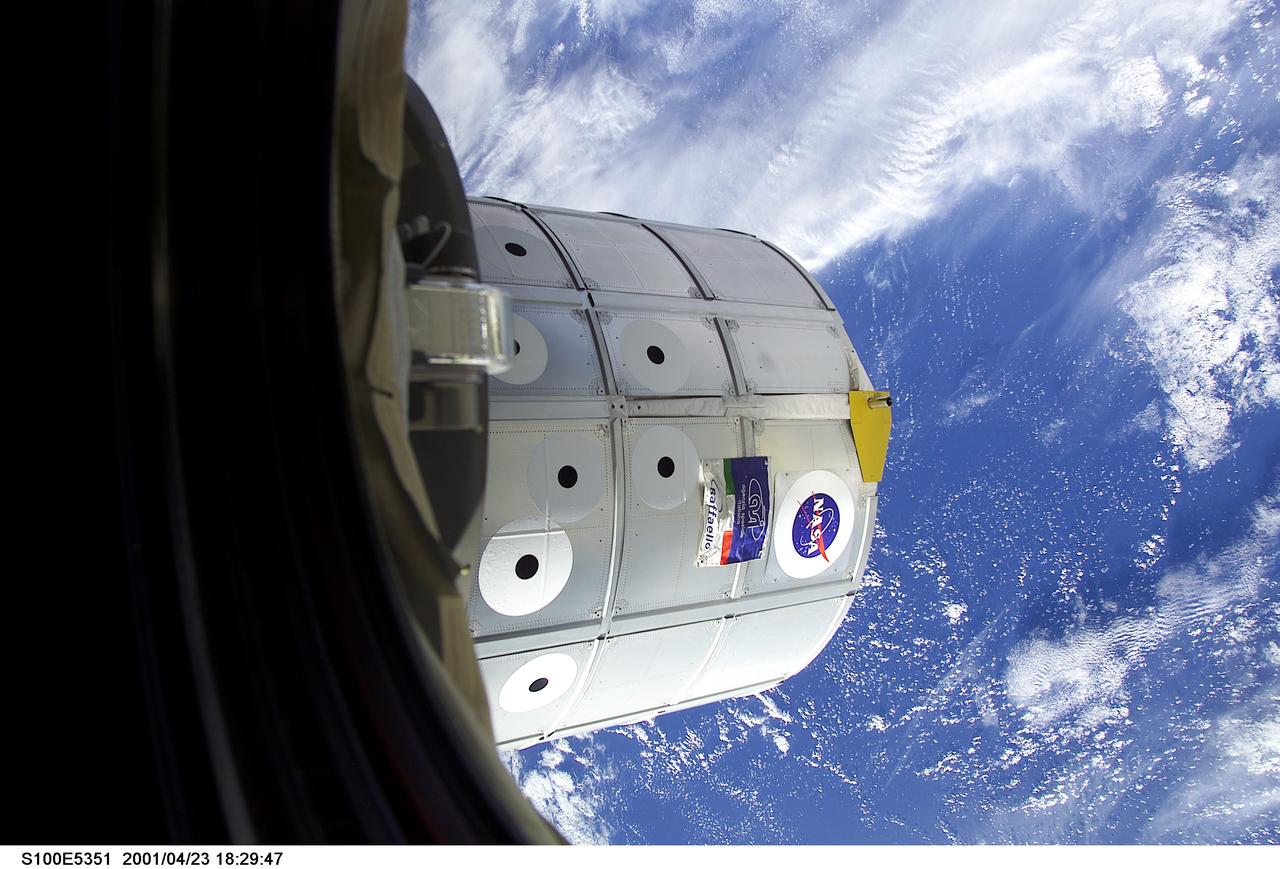 S100-E-5351 (23 April 2001) --- The Raffaello logistics module is backdropped over clouds and water on Earth. Endeavour’s 50-foot robotic arm, operated by astronaut Jeffrey S. Ashby, STS-100 pilot, had  earlier grappled the logistics module in the shuttle's cargo bay and docked it to the Unity module.  The Expedition Two crew was scheduled to begin the following day transferring food, supplies, equipment and two experiment racks for installation in Destiny from Raffaello to the station.   The image was recorded with a digital still camera.