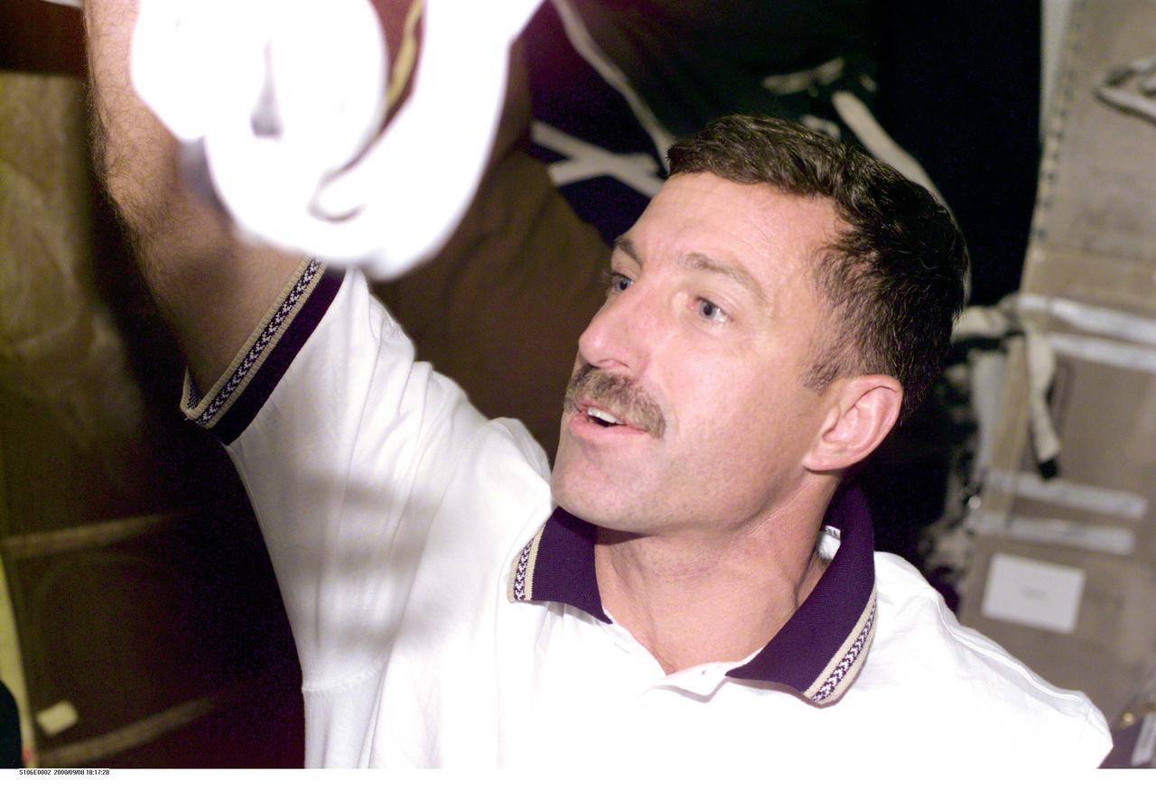 S106-E-5002 (8 September 2000) --- Getting Atlantis ready to support  the duration of the STS-106 mission is  Daniel C. Burbank, mission specialist.  This electronic still camera's (ESC) photo was among the first downlinked by the Atlantis crew on Flight Day 1.