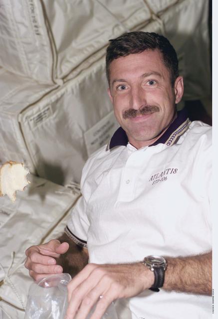 NASA image: MS Dan Burbank eats a sandwich aboard Atlantis during STS-106