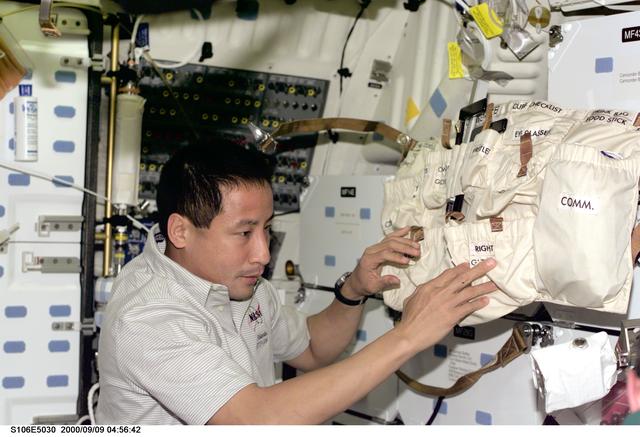 NASA image: MS Lu works with stowage bags aboard Atlantis during STS-106