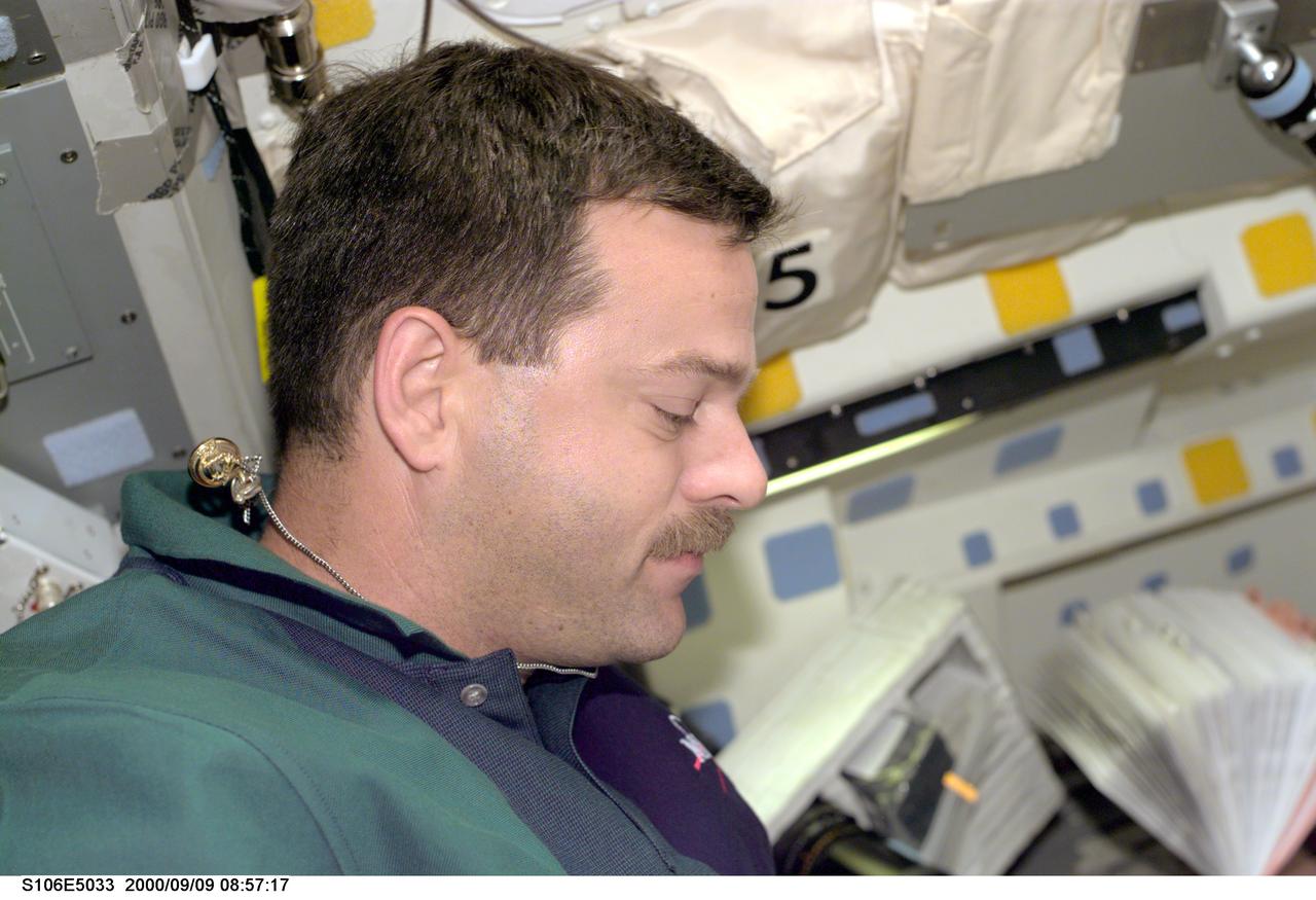 S106-E-5033 (9 September 2000) --- Astronaut Scott D. Altman,  STS-106 pilot, is looking down at a checklist in this electronic still camera's (ESC)   view, recorded during busy Flight Day 2 activity onboard the Earth-orbiting Space Shuttle Atlantis.