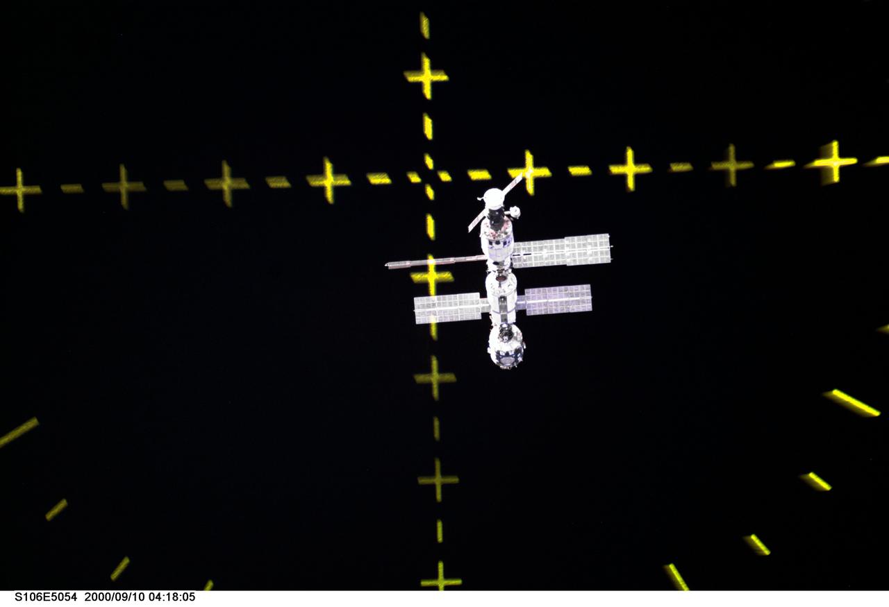 S106-E-5054 (10 September 2000) --- The International Space Station (ISS) is now in the view of the crew aboard the Space Shuttle Atlantis as evidenced in this electronic image. The markings in the photo are those of the Crew Optical Alignment Sight (COAS), an instrument used routinely for docking maneuvers. The last time astronauts saw the ISS, it was not sporting the recently-arriving Progress, which appears at the top in this perspective. Also, a Proton had earlier delivered the Zvezda service module to the station since the last human visit.