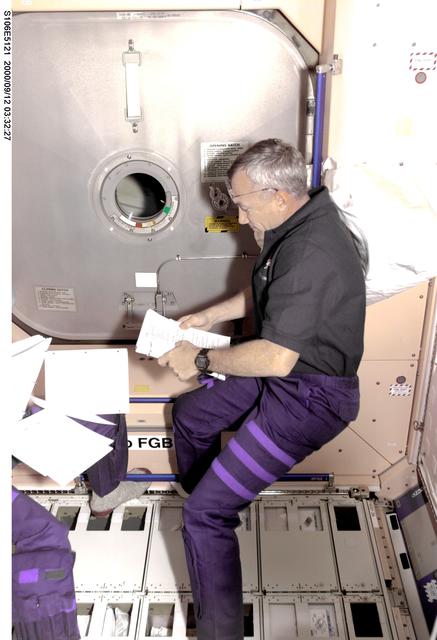 NASA image: Commander Wilcutt reviews his agenda in Node 1 during STS-106