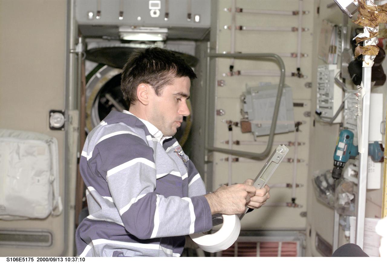 S106-E-5175 (13 September) --- Cosmonaut Yuri I. Malenchenko, representing the Russian Aviation and Space Agency, tapes brackets for the   Zvezda during work on the service module. The mission specialist and  the other STS-106 astronauts and cosmonaut are continuing electrical work and transfer activities as they near the halfway point of docked operations with the International Space Station. In all the crew will have 189 hours, 40 minutes of planned Atlantis-ISS docked time.