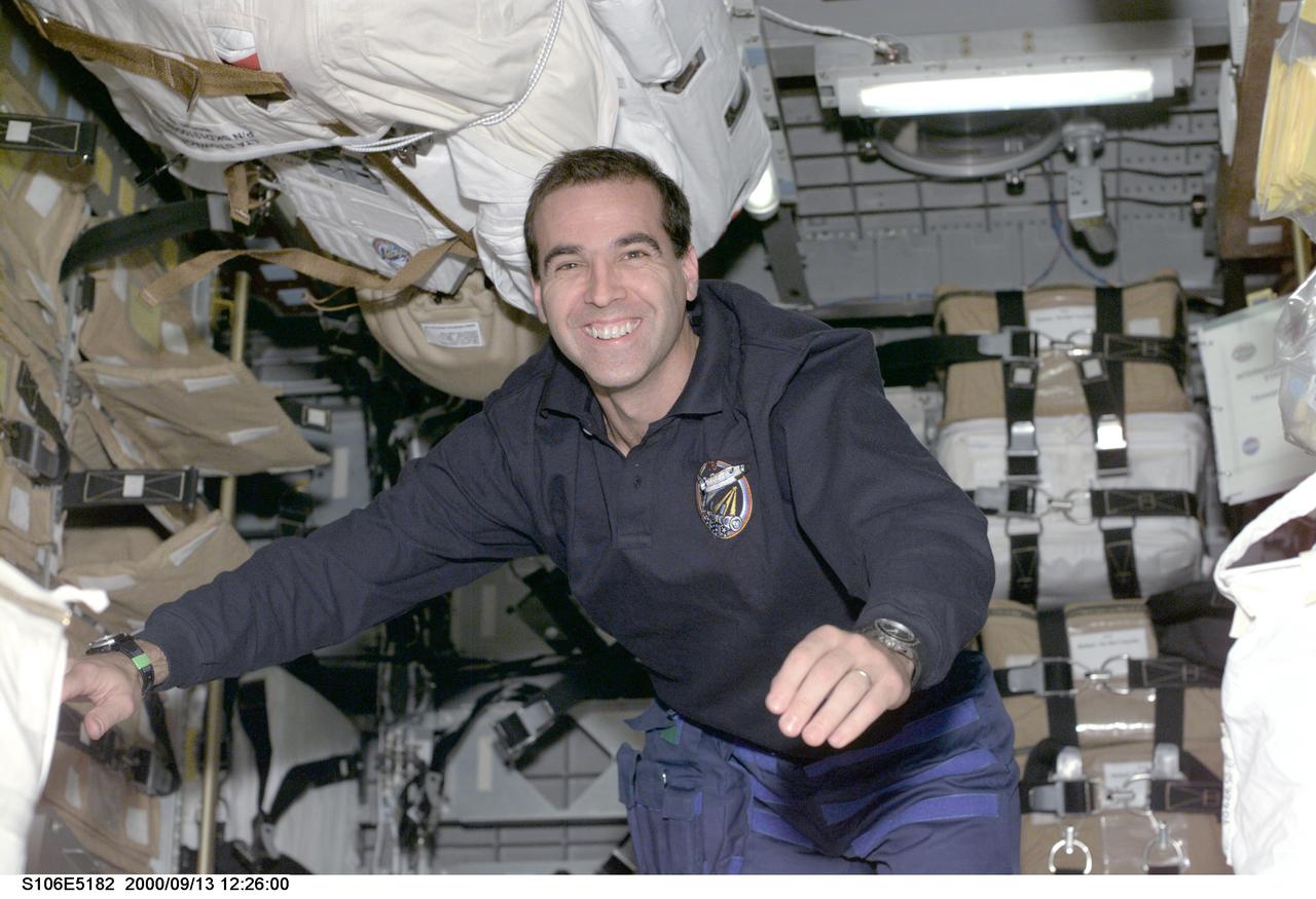 S106-E-5182 (13 September 2000) --- While crewmates (out of frame) do electrical work on the International Space Station (ISS), astronaut Richard A. Mastracchio, mission specialist, is in Spacehab to participate in the effort to move supplies. Mastracchio is one of the crew members who are working together to unload supplies from both a double Spacehab cargo module in the rear of Atlantis’ cargo bay and from a Russian Progress M-1 resupply craft docked to the aft end of the Zvezda Service Module. Zvezda, which linked up to the ISS on July 26, will serve as the early living quarters for the station and is the cornerstone of the Russian contribution to the ISS.