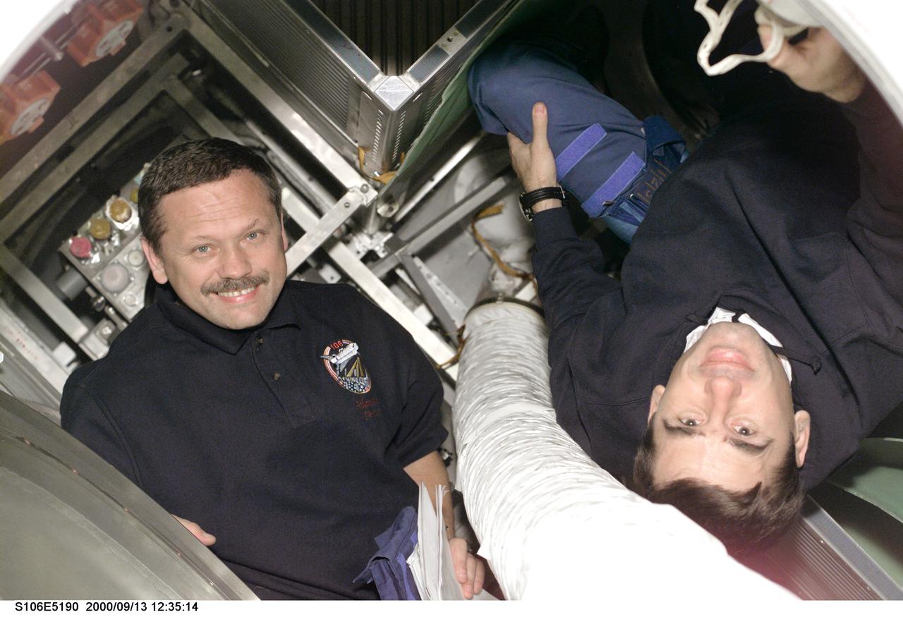 S106-E-5190 (13 September 2000) ---   Part of Flight Day 5 activity included interface with the Progress supply vehicle which joined the International  Space Station (ISS) last month.  Pictured in the supply vehicle are cosmonauts Boris V. Morukov, left, and Yuri I. Malenchenko, both mission specialists representing the Russian Aviation and Space Agency.