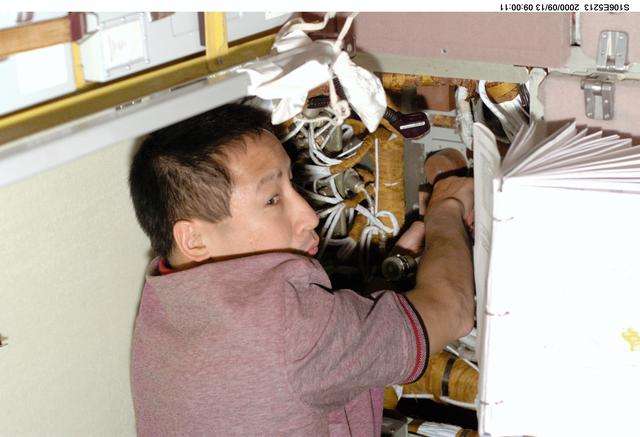 NASA image: MS Lu conducts electrical work in Zvezda during STS-106