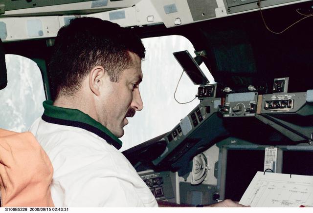 NASA image: MS Burbank works at the commander's workstation in Atlantis during STS-106