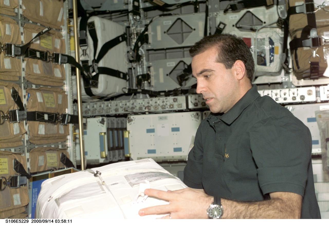 S106-E-5229 (14 September 2000) ---   Astronaut Richard A. Mastracchio, mission specialist, works with packages of supplies in the Spacehab double module in the cargo bay of the Earth-orbiting Space Shuttle Atlantis.