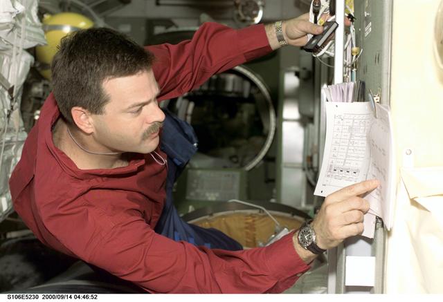 NASA image: Pilot Altman checks the timeline in Zvezda during STS-106