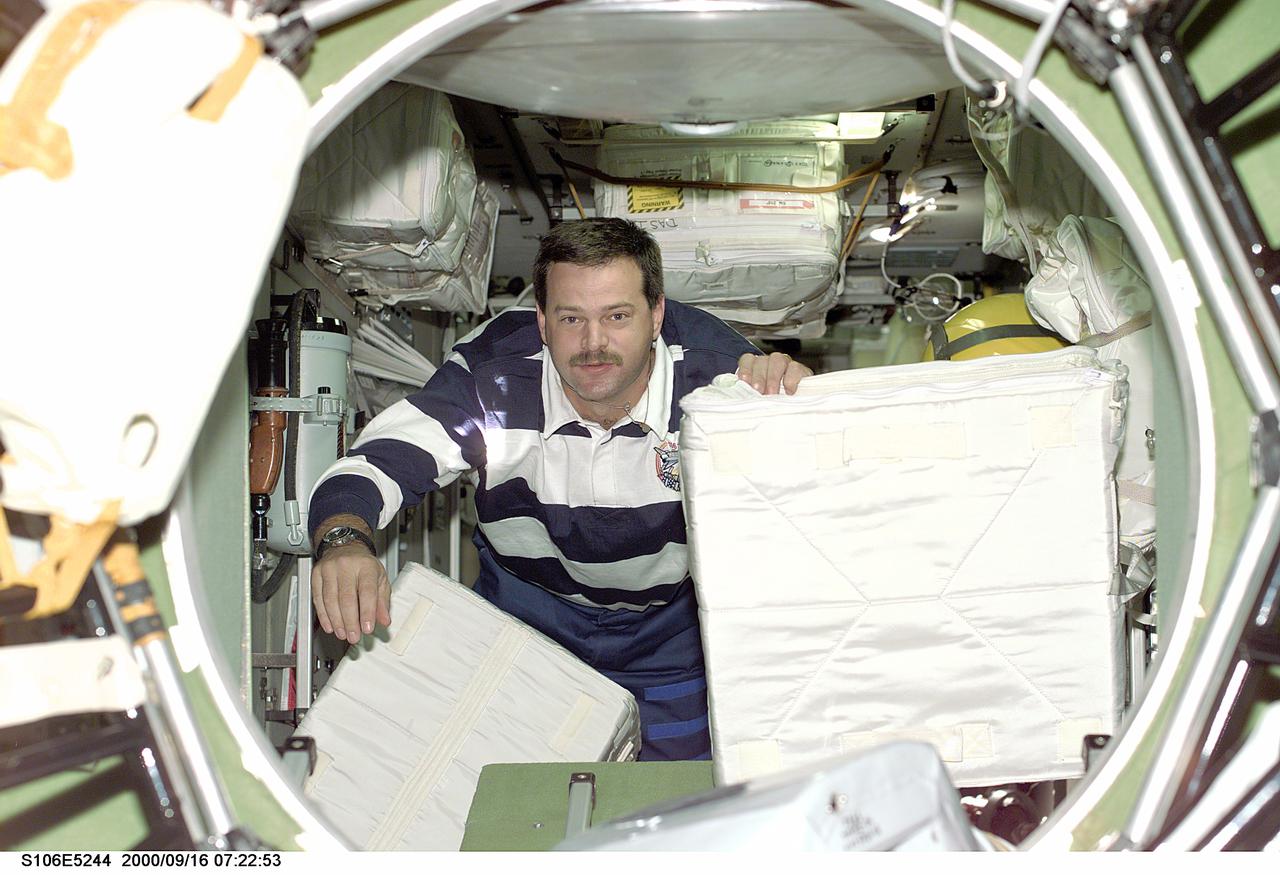 S106-E-5244 (16 September 2000) --- Downlinked images from the STS-106 mission aboard the Earth-orbiting Space Shuttle Atlantis have exhibited the common denominator of scenery of objects in transit and movers at work.  This scene of astronaut Scott D. Altman, pilot, aboard the International Space Station (ISS) is no different as the crew heads toward final touches on their ISS tasks and separation from the station.