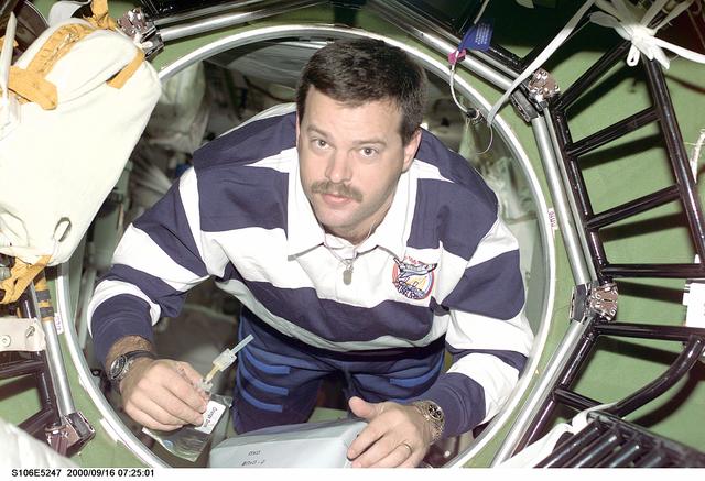 NASA image: Pilot Altman moves through a hatch in the ISS during STS-106
