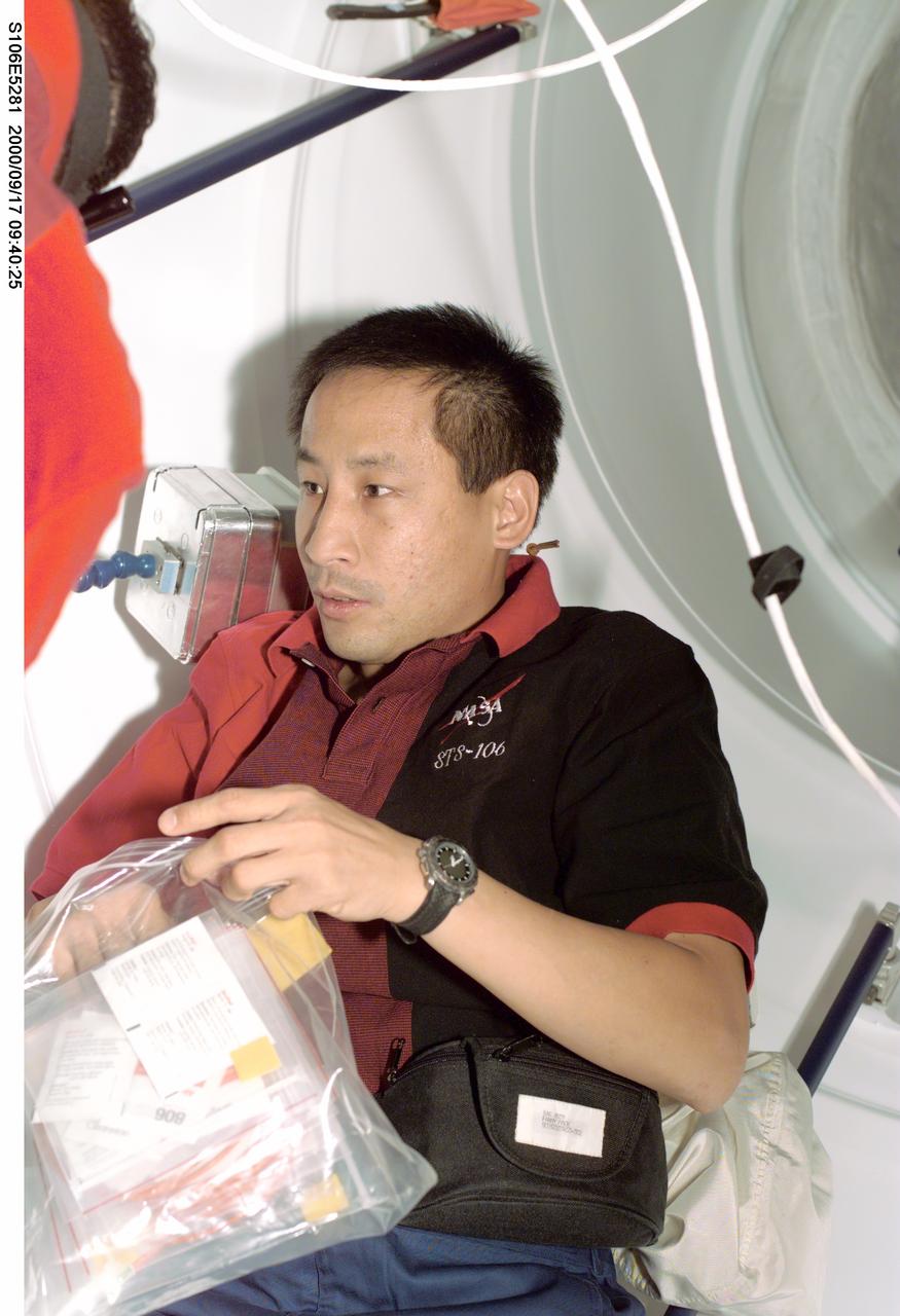 S106-E-5281 (17 September 2000) --- Astronaut Edward T. Lu, mission specialist, can literally see the light at the end of the tunnel, as he and six  STS-106 crewmates wind down toward the   end of their interface with the International Space Station (ISS).  The crew soon will be sealing itself off from the station and returning to the crew cabin of Atlantis and Spacehab for the remainder of the 12-day mission.