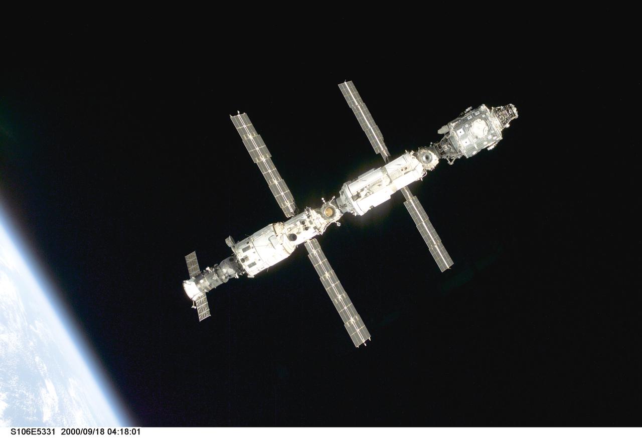 S106-E-5331 (18 September 2000) --- Backdropped against black space above Earth's horizon, the International Space Station (ISS) is seen following its undocking with the Space Shuttle Atlantis. After accomplishing all mission objectives in outfitting the station for the first resident crew, the seven astronauts and cosmonauts undocked at 3:46 GMT on Sept. 18 over Russia near the northeastern portion of Ukraine. When Atlantis was at a safe distance from the station, about 450 feet, astronaut Scott D. Altman, pilot, performed a 90-minute, double-loop fly around to enable the crew to document the station’s exterior. He fired Atlantis’ jets one final time to separate from the station at 5:35 (GMT) September 18.