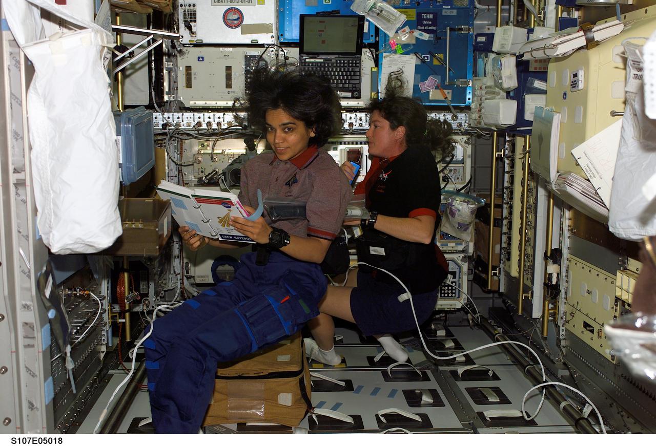 STS107-E-05018 (17 January 2003) --- Astronaut Kalpana Chawla (foreground) and Laurel B. Clark, STS-107 mission specialists, work in the SPACEHAB Research Double Module aboard the Space Shuttle Columbia.