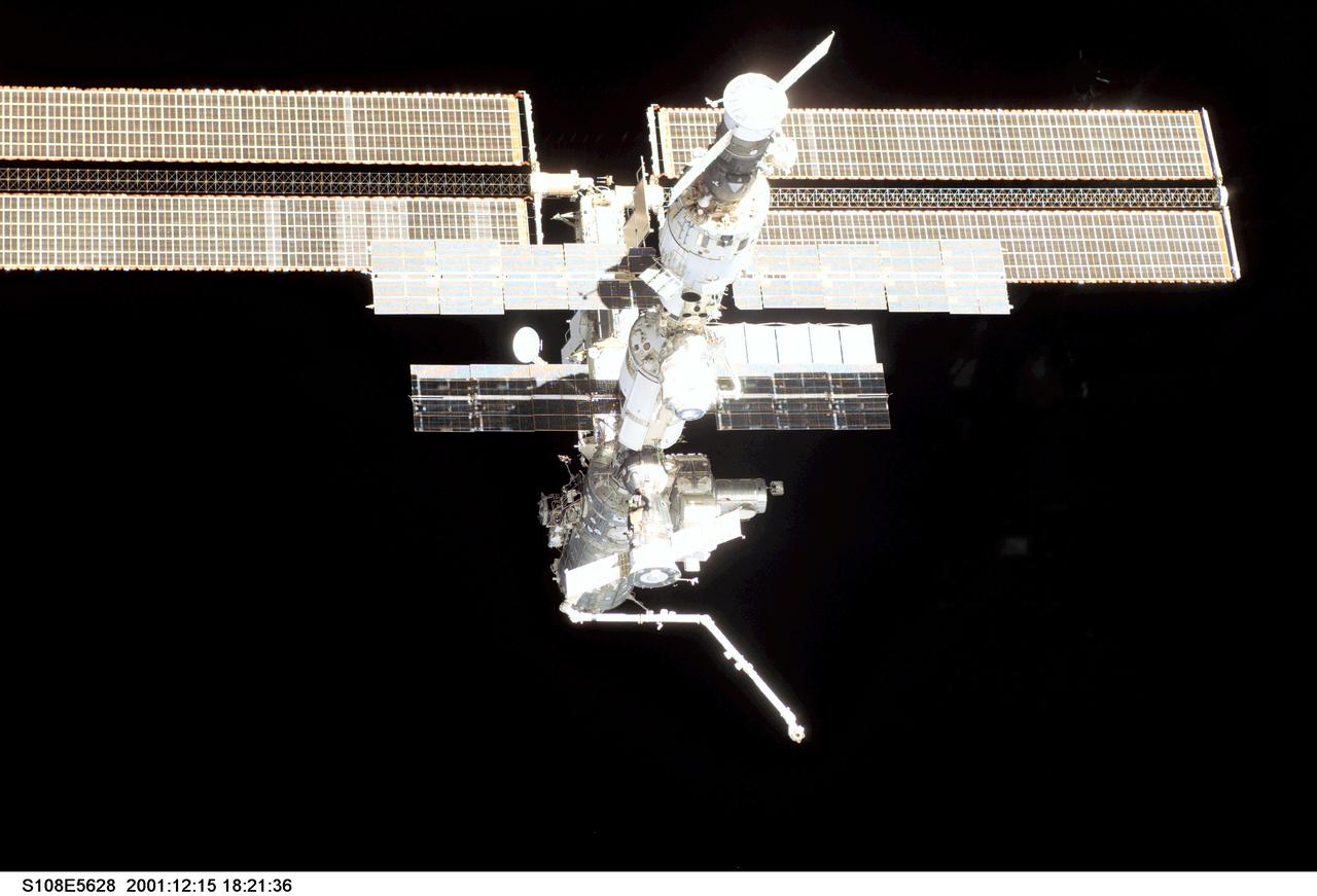 STS108-E-5628 (15 December 2001) ---  As seen in an overall view from a digital still camera aimed through a window on Endeavour's aft flight deck, the International Space Station (ISS), now staffed with its fourth three-person crew, is backdropped against dark space. The scene was photographed during a farewell look from the shuttle following undocking. The Space Station Remote Manipulator System (SSRMS) or Canadarm2 protrudes from the orbital outpost at the bottom of the scene.