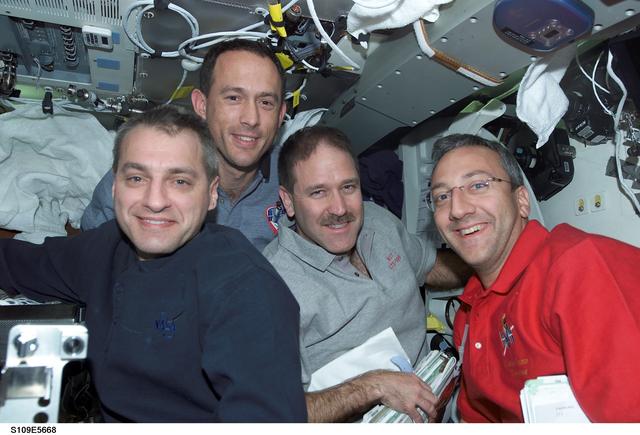 NASA image: STS-109 EVA crewmembers on middeck after EVA 3
