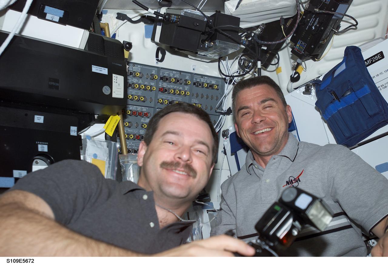 STS109-E-5672 (7 March 2002) --- Astronauts Scott D. Altman, mission commander, and Duane G. Carey, pilot, have remained inside Columbia's crew cabin all week while four crewmates have performed a series of space walks. However, the duo, seen here on the shuttle's flight deck, has had sparse leisure time, performing various interior duties in support of the extravehicular activity (EVA) designed for the servicing and upgrading of the Hubble Space Telescope (HST). The image was recorded with a digital still camera.