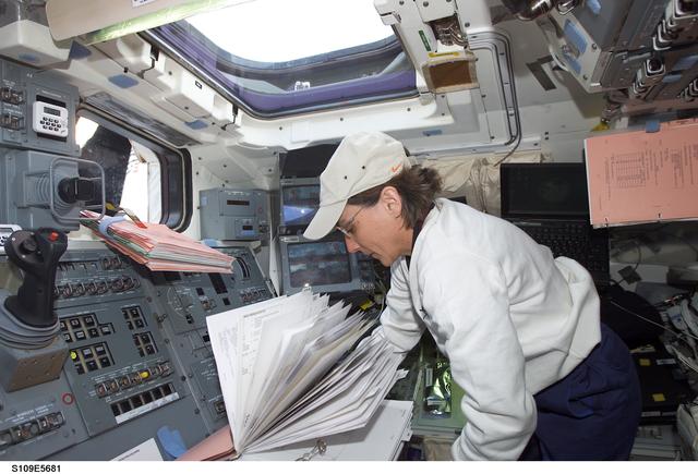 NASA image: MS Currie on aft flight deck with checklist