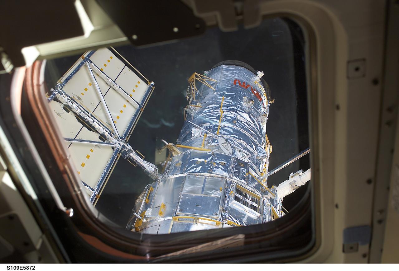 HST removed from payload bay by RMS arm