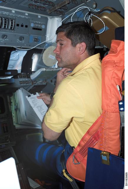 NASA image: Lockhart reviews a checklist from the PLT's seat on Shuttle Endeavour's FD during STS-111 UF-2