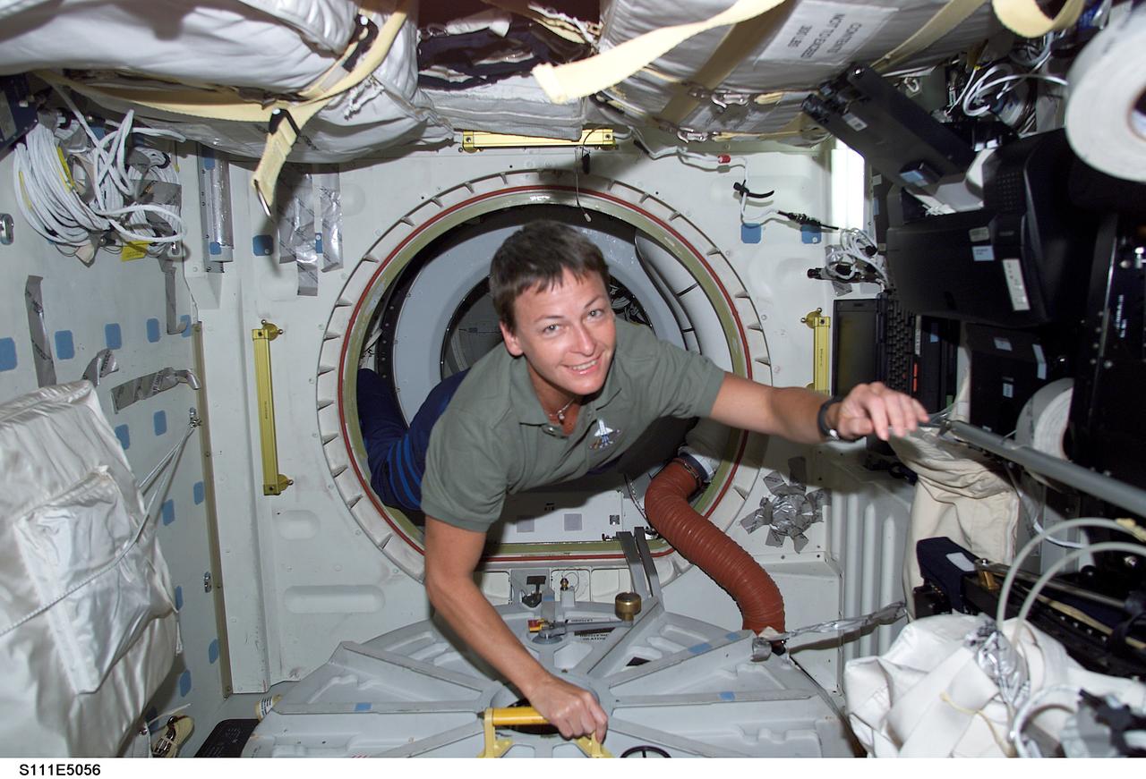 STS111-E-5056 (7 June 2002) --- Astronaut Peggy A. Whitson is pictured in the Pressurized Mating Adapter (PMA-2) near the entrance way into the Destiny laboratory on board the International Space Station (ISS). She is beginning this week to serve a lengthy tour of duty as flight engineer for the fifth crew to live and work aboard the orbiting outpost.