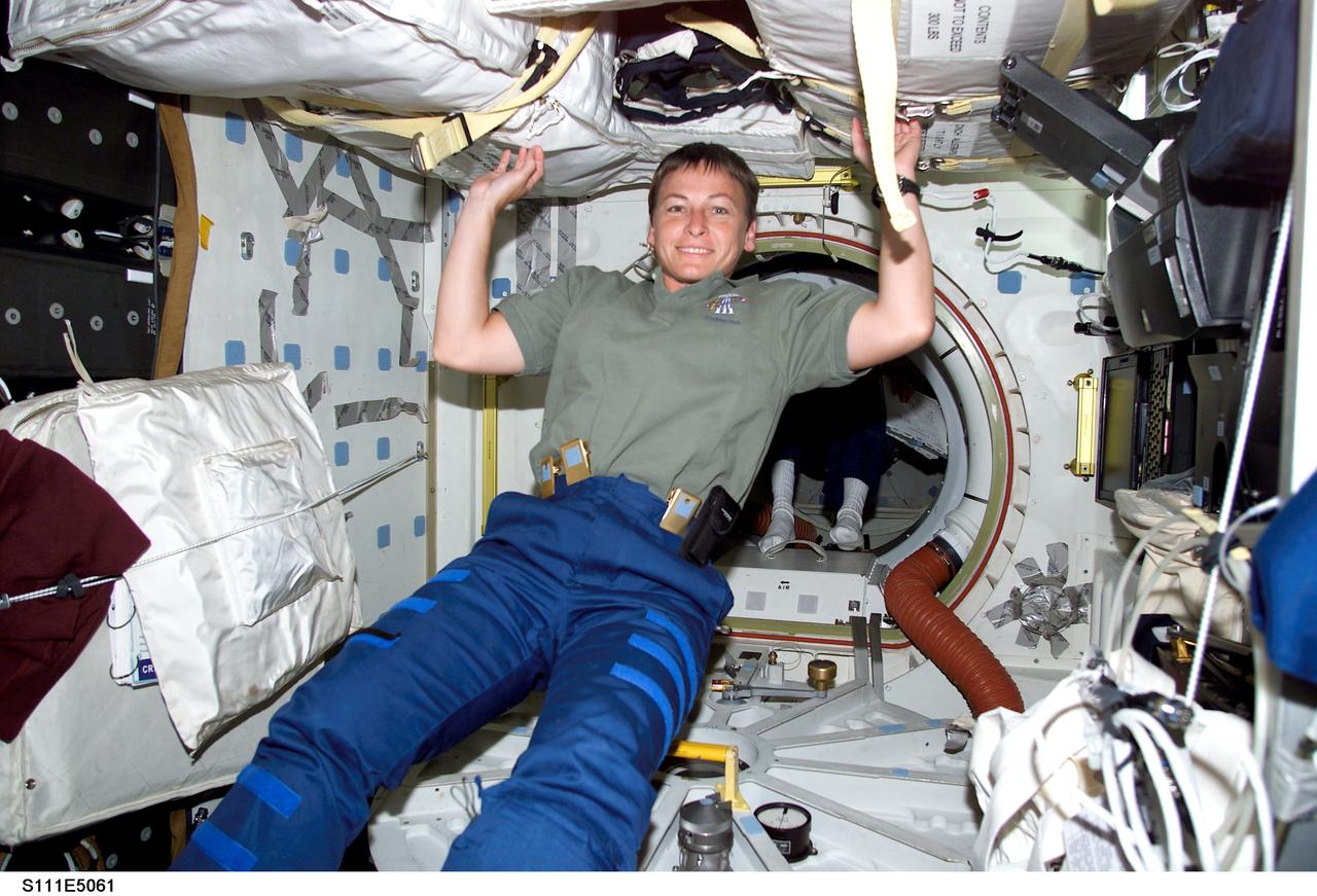 STS111-E-5061 (7 June 2002) --- Astronaut Peggy A. Whitson is pictured as she passes into the Pressurized Mating Adapter (PMA-2) on board the International Space Station (ISS).  She is beginning this week to serve a lengthy tour of duty as flight engineer for the fifth crew to live and work aboard the orbiting outpost.