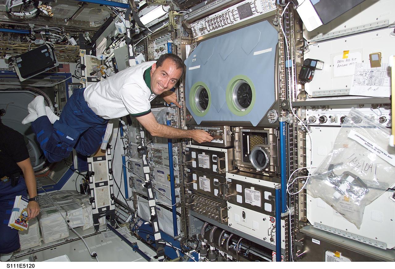 STS111-E-5120 (9 June 2002) --- Astronaut Philippe Perrin, STS-111 mission specialist, floats near the Microgravity Science Glovebox (MSG) in the Destiny laboratory on the International Space Station (ISS). Perrin represent CNES, the French Space Agency.