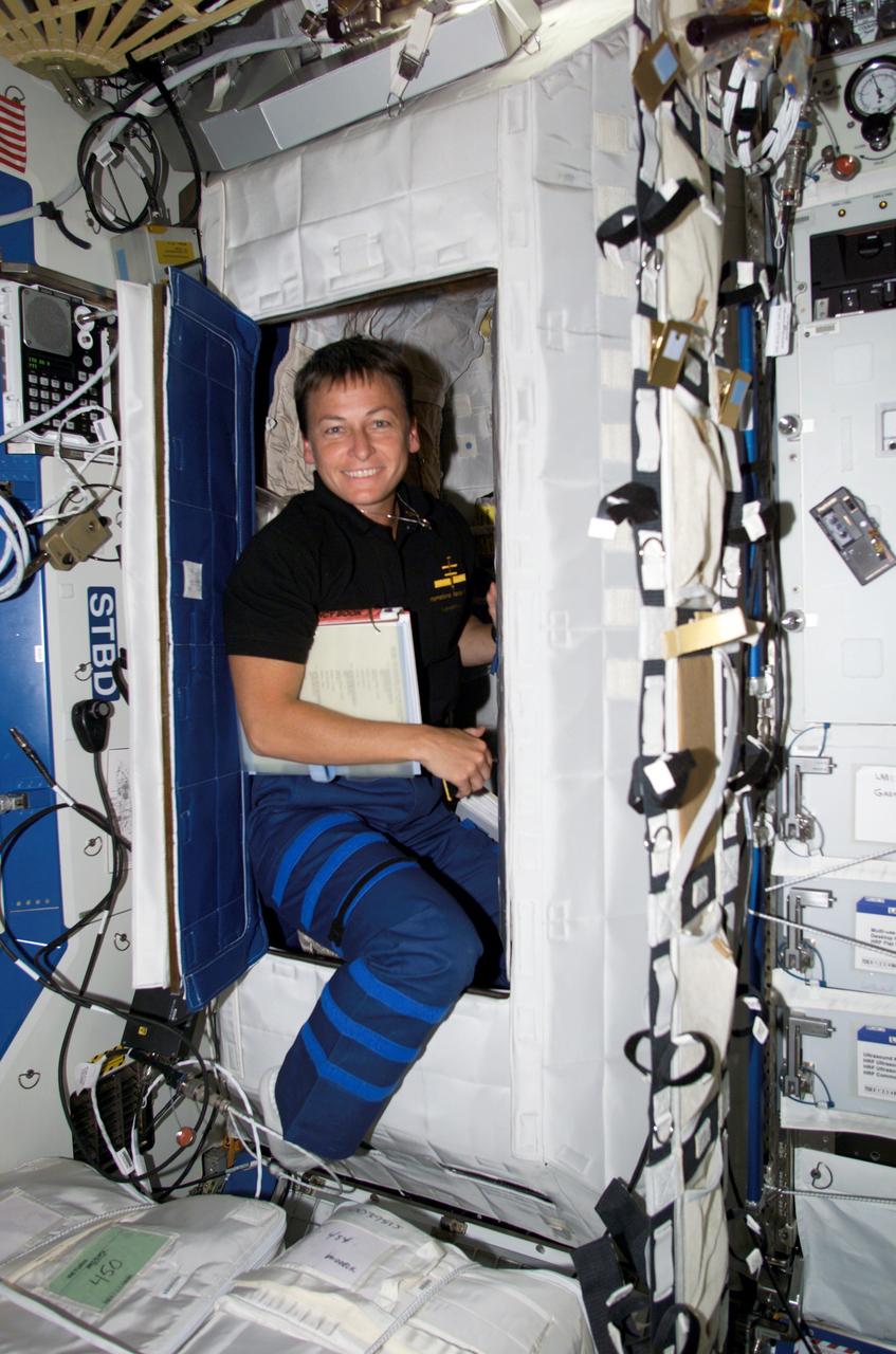 STS111-E-5122 (9 June 2002) --- Astronaut Peggy A. Whitson, Expedition Five flight engineer, was photographed in the doorway of the Temporary Sleep Station (TSS) in the Destiny laboratory on International Space Station (ISS).