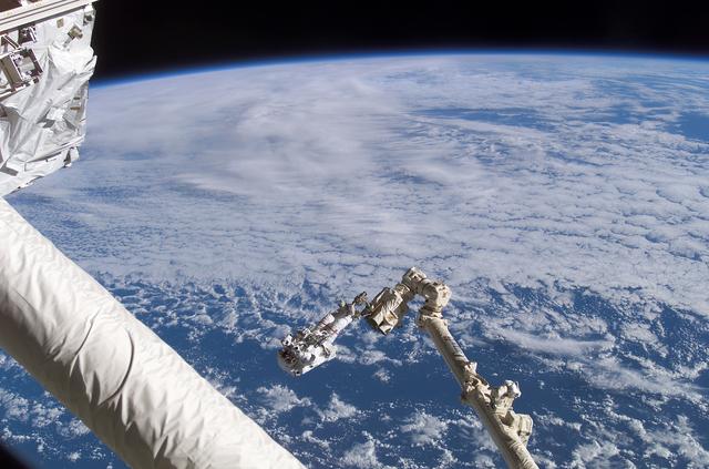 NASA image: Chang-Diaz on the Canadarm2 SSRMS backdropped against Earth limb during  STS-111 UF-2 EVA 1