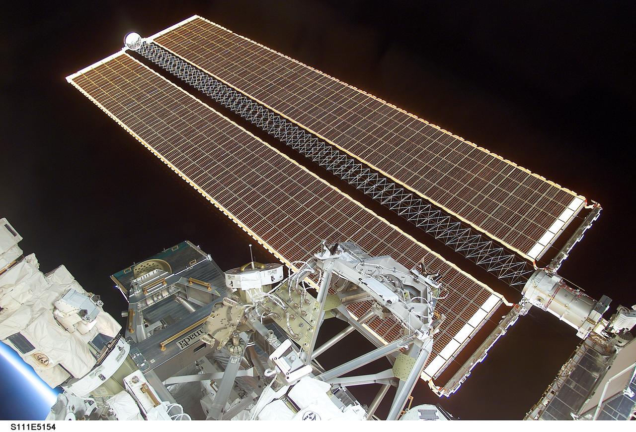 STS111-E-5154 (10 June 2002) --- Backdropped by the blackness of space, this view of the starboard solar array wing panel of the International Space Station (ISS) was photographed with a digital still camera from inside the crew cabin of the Space Shuttle Endeavour.