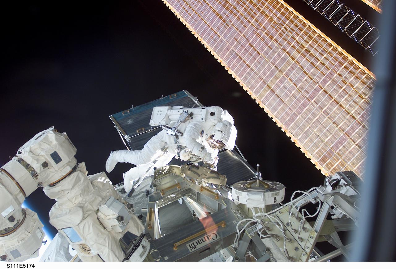 STS111-E-5174 (11 June 2002) --- Astronaut Philippe Perrin, mission specialist representing CNES, the French Space Agency, participates in the second scheduled session of extravehicular activity (EVA) for the STS-111 mission. During the spacewalk, Perrin and Chang-Diaz attached power, data and video cables from the International Space Station (ISS) to the Mobile Base System (MBS) and used a power wrench to complete the attachment of the MBS onto the Mobile Transporter (MT).