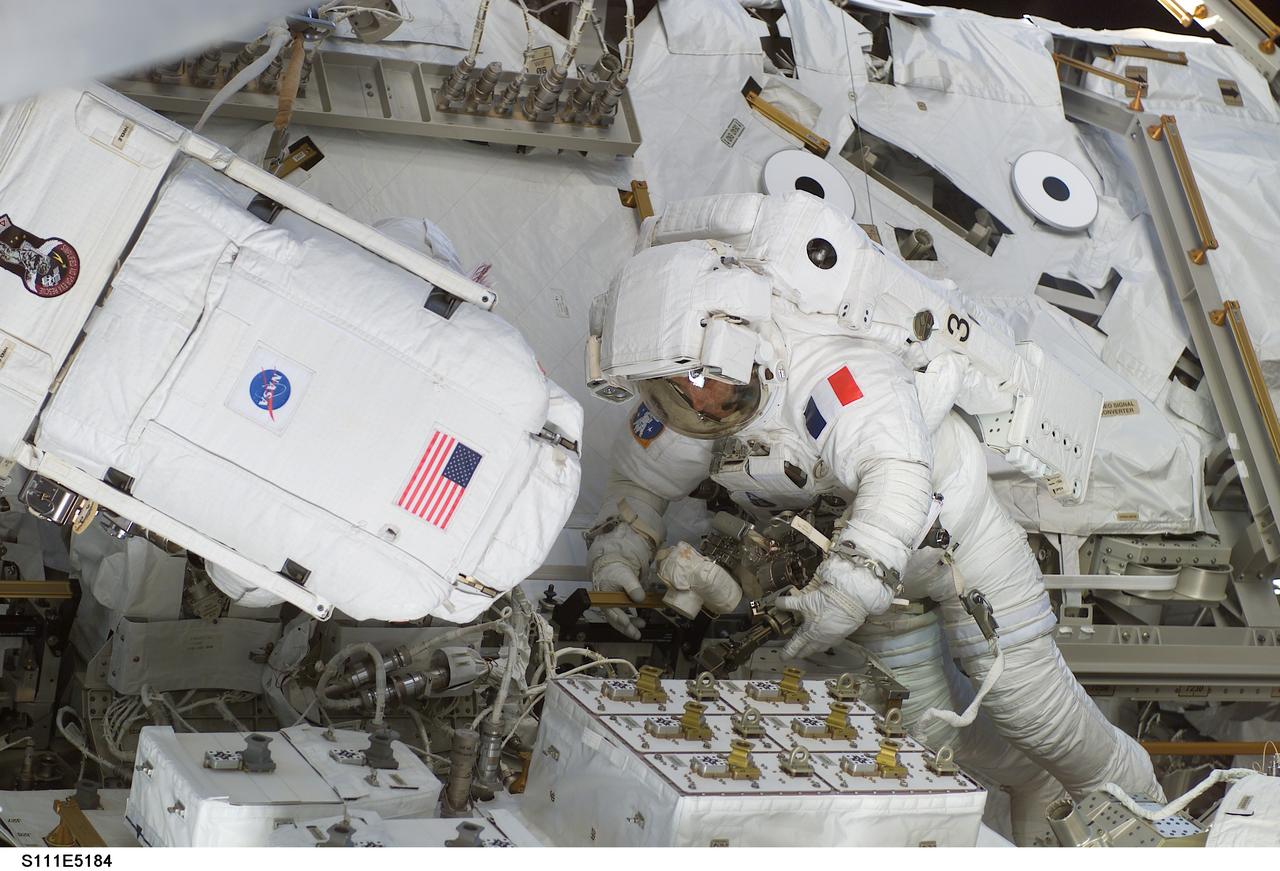 STS111-E-5184 (11 June 2002) --- Astronauts Franklin R. Chang-Diaz (left) and Philippe Perrin, both mission specialists, work on the Mobile Remote Servicer Base System (MBS) and the Mobile Transporter on the International Space Station (ISS) during the second scheduled session of extravehicular activity (EVA) for the STS-111 mission. The boxes in front of the spacewalkers are the Canadian Remote Power Control Modules (RPCM). The S0 (S-zero) Truss is partially visible in the background. Perrin represents CNES, the French Space Agency.