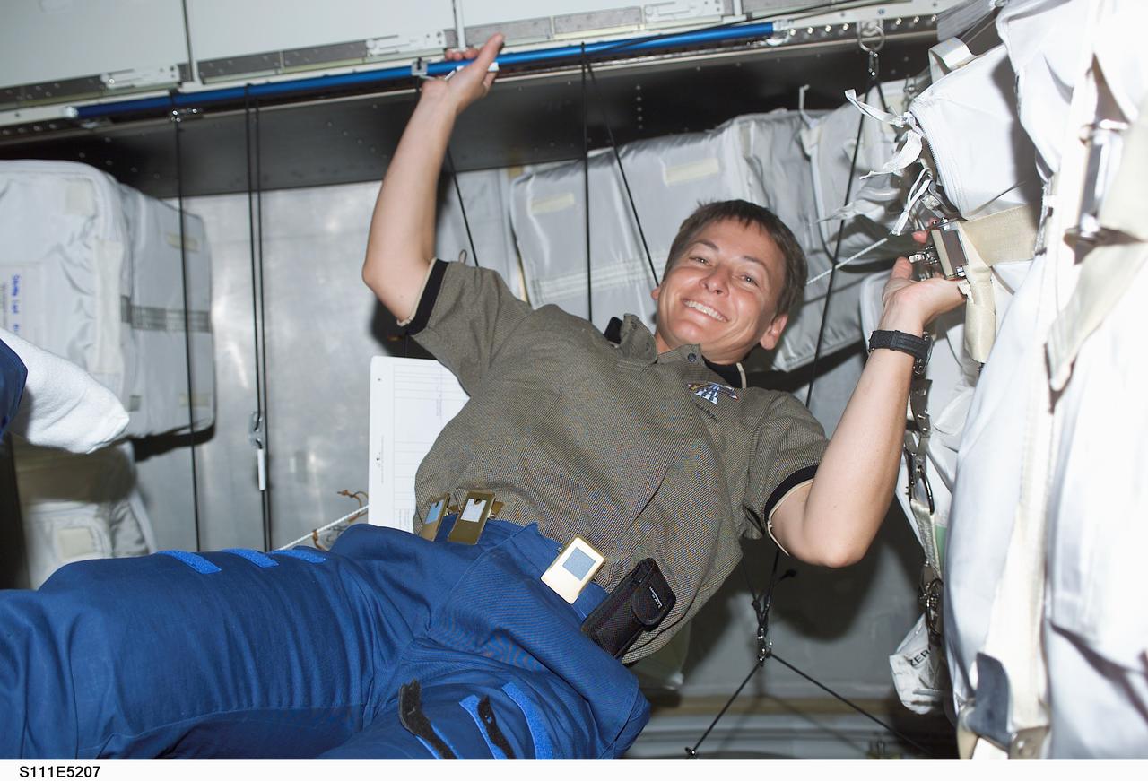 STS111-E-5207 (12 June 2002) --- Astronaut Peggy A. Whitson, Expedition Five flight engineer, is photographed in Leonardo Multi-Purpose Logistics Module (MPLM) on the International Space Station (ISS).