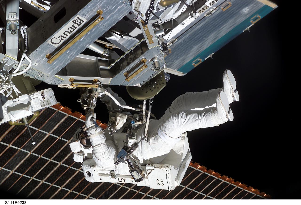 STS111-E-5238 (11 June 2002) --- Astronaut Philippe Perrin, STS-111 mission specialist, works on the installation of the Mobile Remote Servicer Base System (MBS) on the International Space Station’s (ISS) railcar, the Mobile Transporter, during the second scheduled session of extravehicular activity (EVA) for the STS-111 mission. Perrin represents CNES, the French Space Agency.