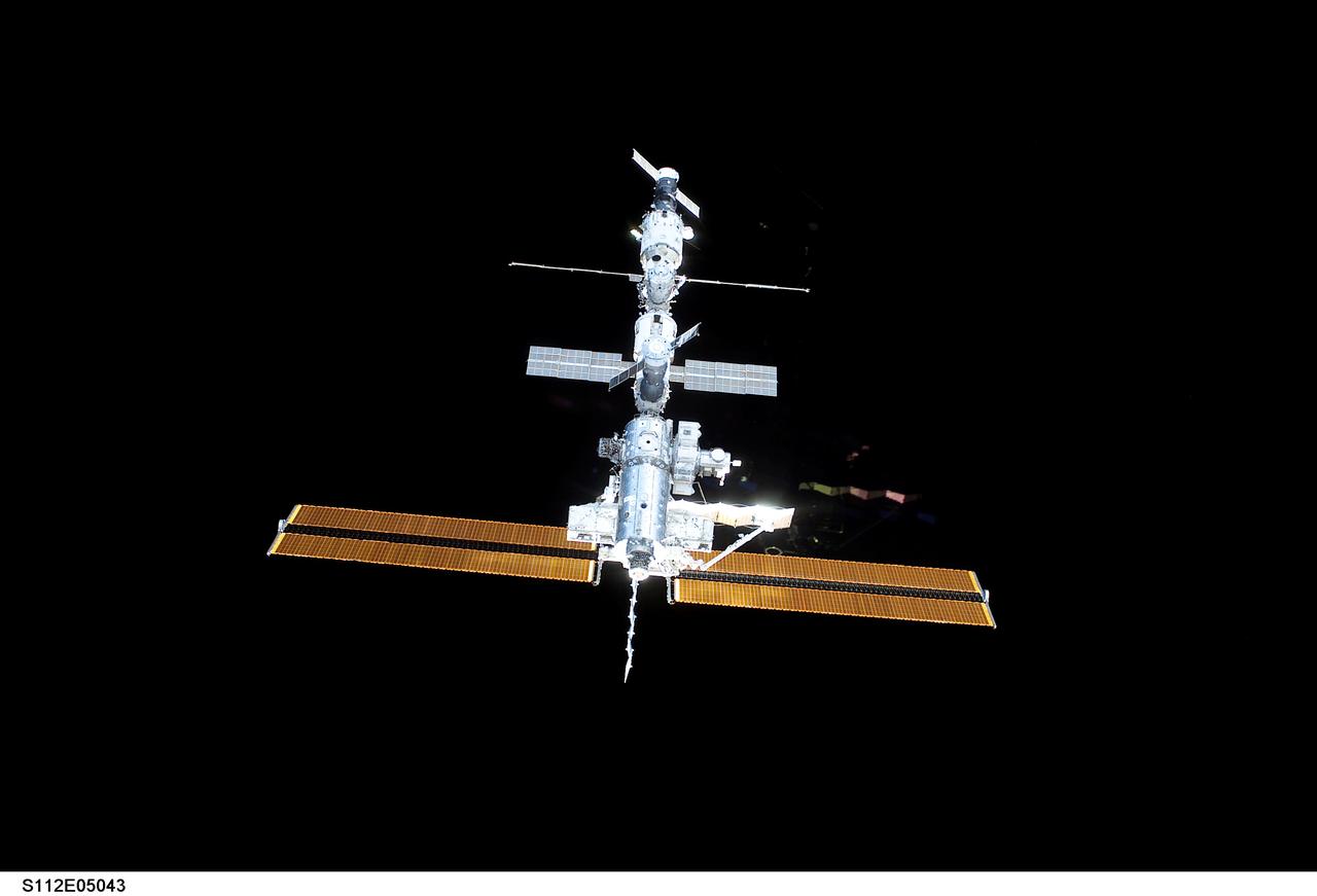 STS112-E-05043 (9 October 2002) --- Backdropped by the blackness of space, the International Space Station (ISS) was photographed by a crewmember aboard the Space Shuttle Atlantis during rendezvous and docking operations. Docking occurred at 10:17 a.m. (CDT) on October 9, 2002.